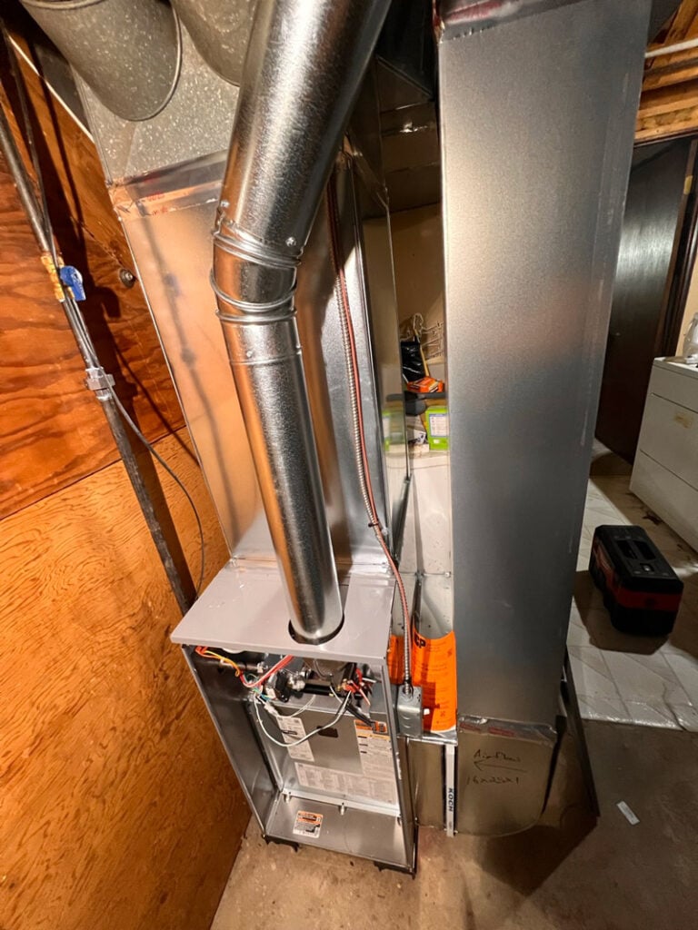 Professional HVAC services being performed on a residential climate control system in Metro Detroit.