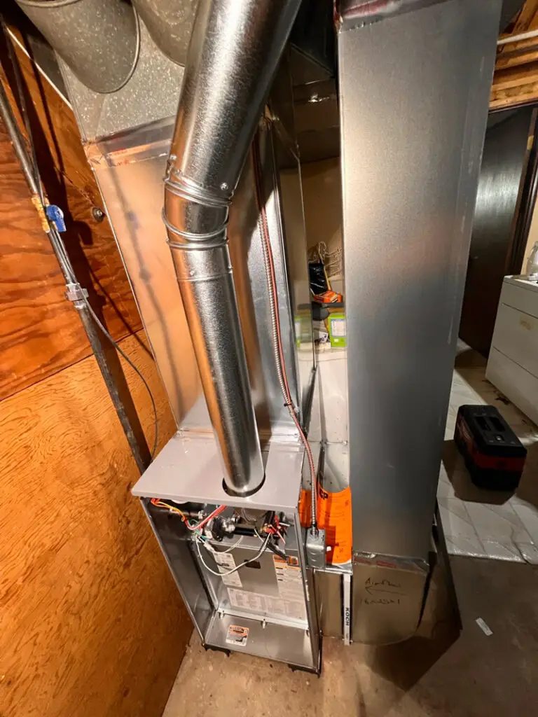 Professional HVAC services being performed on a residential climate control system in Metro Detroit.